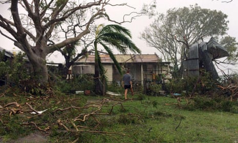 A man enters a badly damaged house after cyclone Marcia hit the coastal town of Yeppoon in north Queensland on Friday.