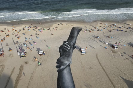 A land-art fresco made with biodegradable paint of charcoal, chalk, water and milk proteins, by French-Swiss artist Saype, covers Copacabana beach as part of the artist’s worldwide project titled Beyond Walls in Rio de Janeiro on 15 July.