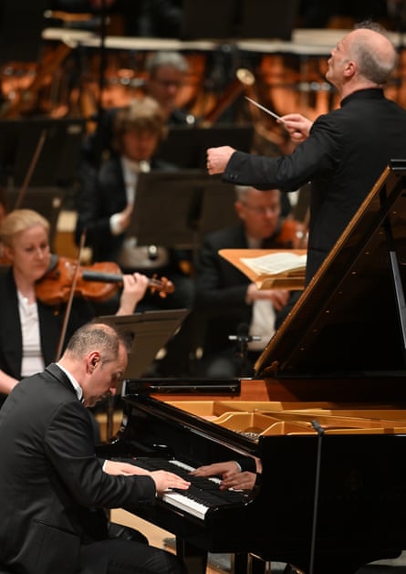 Simon Trpčeski at the piano, head down, performing Beethoven Piano Concerto No 5, with conductor Gianandrea Noseda standing nearby conducting the London Symphony Orchestra