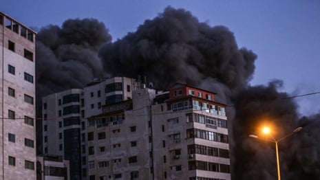 Israeli airstrike collapses tower block and Hamas rocket hits bus as violence escalates – video