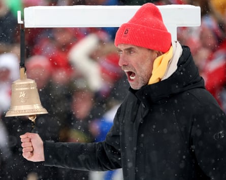 Jürgen Klopp, the former Liverpool and Borussia Dortmund manager and Red Bull’s current global head of soccer, shouts as he rings the bell to indicate the final lap in the men’s 4 x 7.5km biathlon relay at the 2026 Winter Olympics
