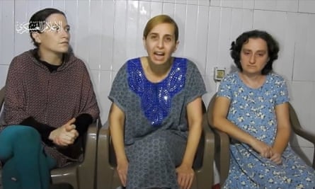 Three hostages sitting down