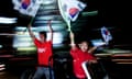 South Korean soccer fans wave their national flag from a moving car as they celebrate South Korea's win over Italy in a second round World Cup match in 2002