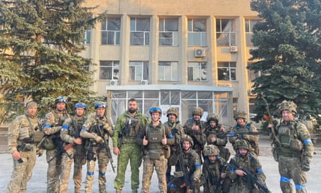 Ukrainian troops pose for a photo in Lyman