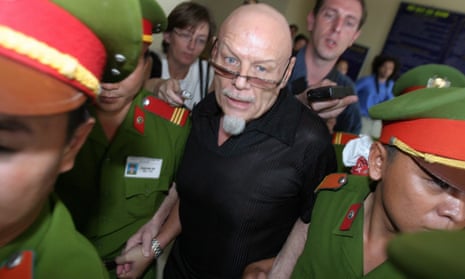 Gary Glitter is escorted from court in March 2006 after being convicted of obscene acts in Vietnam.