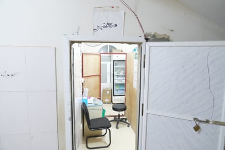 A small room with a chair and a stool