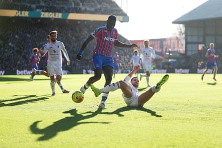Ismaïla Sarr of Crystal Palace is tackled by Diogo Dalot.