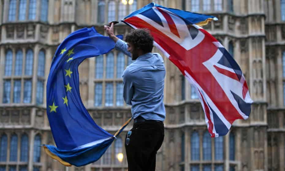 A man waves EU and UK flags outside the Houses of Parliament in London