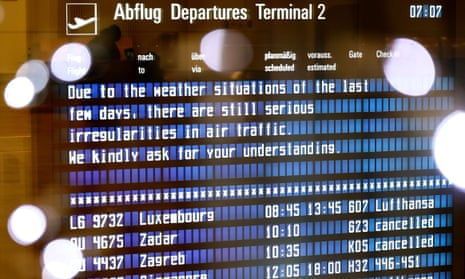 A board announces air traffic delays due to winter weather conditions in Munich