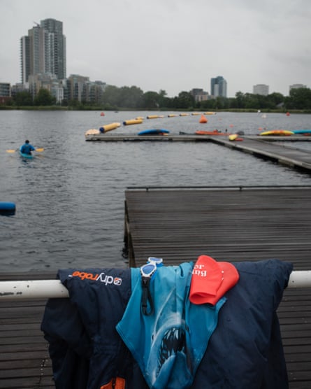 Swimming clothes at the edge of the reservoir with tall buildings in the distance
