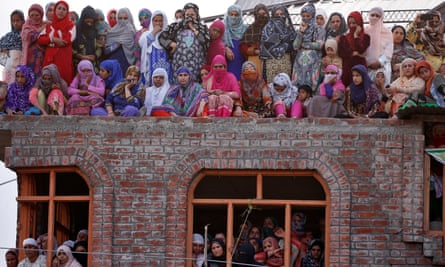 Women watch the body of Dawood Salafi, a suspected militant, during his funeral in Srinagar