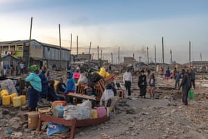 Residents of Mukuru Kwa Njenga informal settlement sit with their belongings after being made homeless by demolition works, 13 November 2021