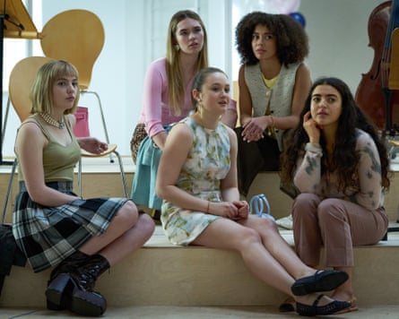 young women in the show Wild Cherry sit on steps inside a building