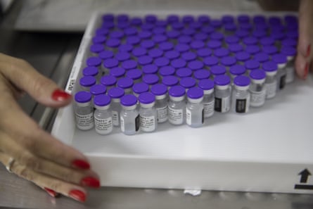 A health worker holds a tray with vials with the Pfizer vaccine at a community medical centre in Sao Paulo, Brazil