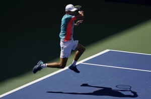 Australia’s Alex de Minaur returns a shot to Vasek Pospisil of Canada.