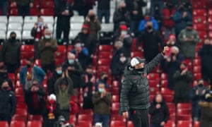 Liverpool manager Jürgen Klopp salutes the returning fans after the final whistle.
