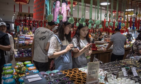 Chinese people visit a shop at the Wangfujing shopping district in Beijing, China
