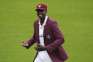 West Indies’ captain Jason Holder smiles as he leaves the ground after winning the toss.