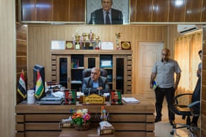 Jalawla’s mayor, Yacop Yusef, in his office, where he has an armed bodyguard and soldiers outside.