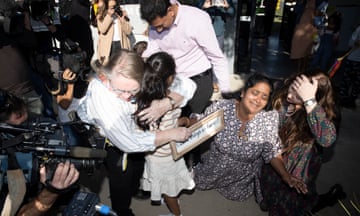 Emotionaal scenes as the Nadesalingam family arrive at Thangool aerodrome to a warm welcome from the locals. Priya and Nade with their daughter Tharnicaa are embraced by jubilant locals as they exit the terminal. Friday 10th June 2022.  Photograph by Mike Bowers. Guardian Australia