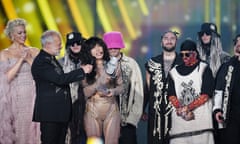Hannah Waddingham, Graham Norton and Kalush Orchestra present winner Loreen with the Eurovision trophy.