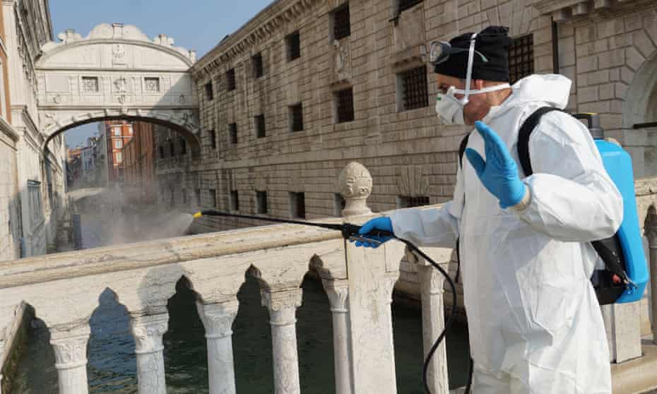 A worker disinfects the historical Marciana area of Venice in Italy.