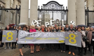 Repeal the 8th Amendment campaigners hold a banner outside government buildings in Dublin.