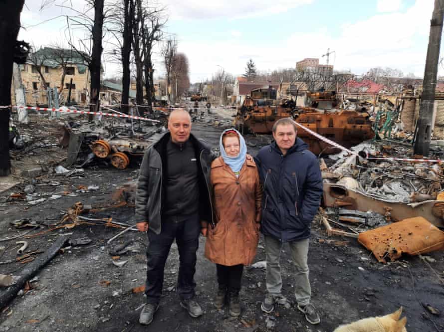 Serhiy and Larisa Savenko from No 35 and their neighbour Yuriy Zaborylo on Vokzal’na Street, Bucha, Ukraine