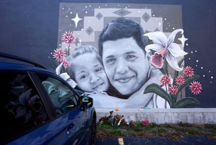 A mural of a young man and a small girl hugging.