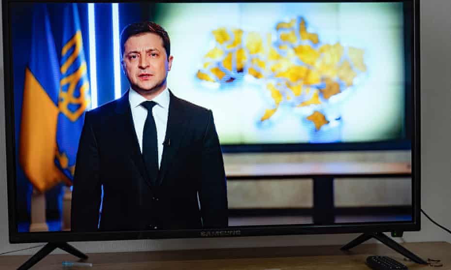 A television screen showing Ukrainian president, Volodymyr Zelenskiy.