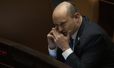 Israeli prime minister Naftali Bennett makes a call before voting on a law on the legal status of Jewish settlers in the occupied West Bank.