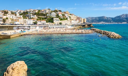 Beach in sunshine with city 