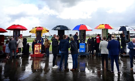 Racegoers place their bets with bookmakers at Aintree during the recent Grand National meeting.