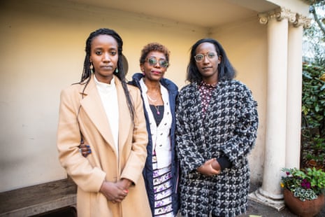 Three Rwandan women look at the camera