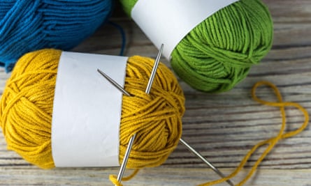 Three balls of wool and knitting needles