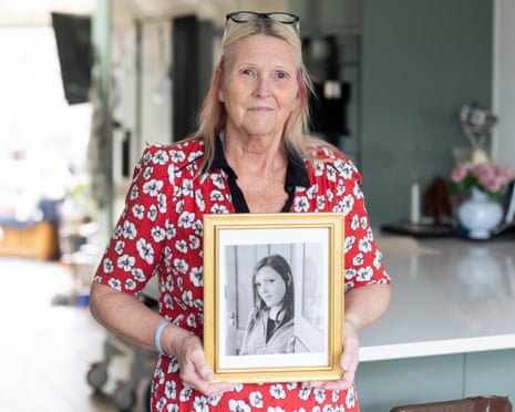 Annette Bramley holds up a framed photograph of her daughter Holly
