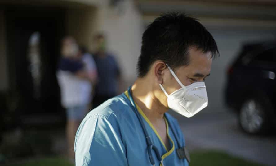 Dr Tien Vo wearing PPE after talking with a family quarantining after they tested positive for coronavirus in California in July 2020.