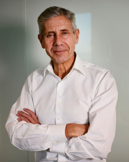 Stuart Rose in an open necked shirt with his arms folded for a photograph