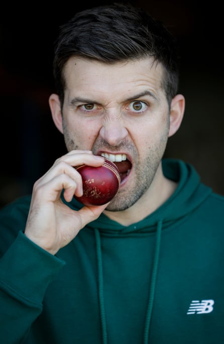 England fast bowler Mark Wood bites a cricket ball