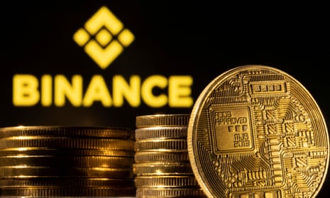 A representation of cryptocurrency is seen in front of Binance logo