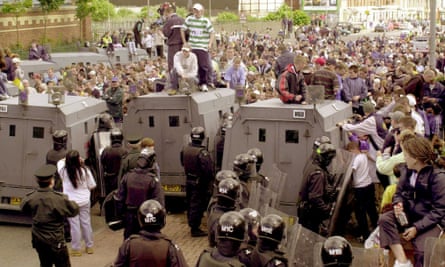 Nationalist protesters confront riot police in west Belfast after a loyalist parade passed close to a Catholic area in Springfield Road, Northern Ireland in June 2000.