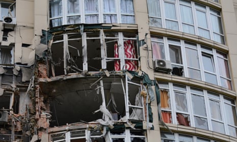 The broken windows and damaged facade of a Kyiv apartment block damaged by a Russian drone shot down by Ukrainian forces.