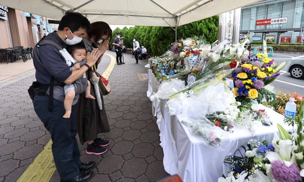 People offer flowers and prayers on Saturday at the site where Shinzo Abe was shot dead in Nara, western Japan
