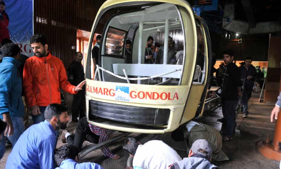 People inspect a section of the cable car which collapsed at Gulmarg, northwest of Srinagar, the summer capital of Indian Kashmir.