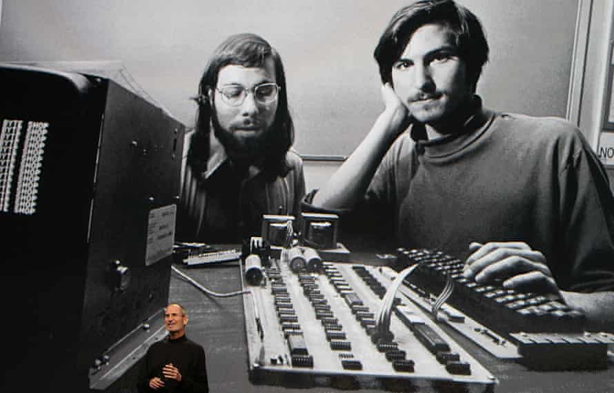 Steve Jobs speaks during an Apple event in 2010 – with a photo of him and Steve Wozniak in the background.