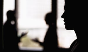 Side profile on a businesswoman with coworkers in the background