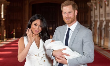 Meghan and Harry pose for a photo with their newborn baby son Archie in St George’s Hall at Windsor Castle.