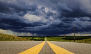 Storm clouds build over a highway