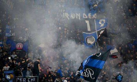 Atalanta's fans wave flags as their team win the game.