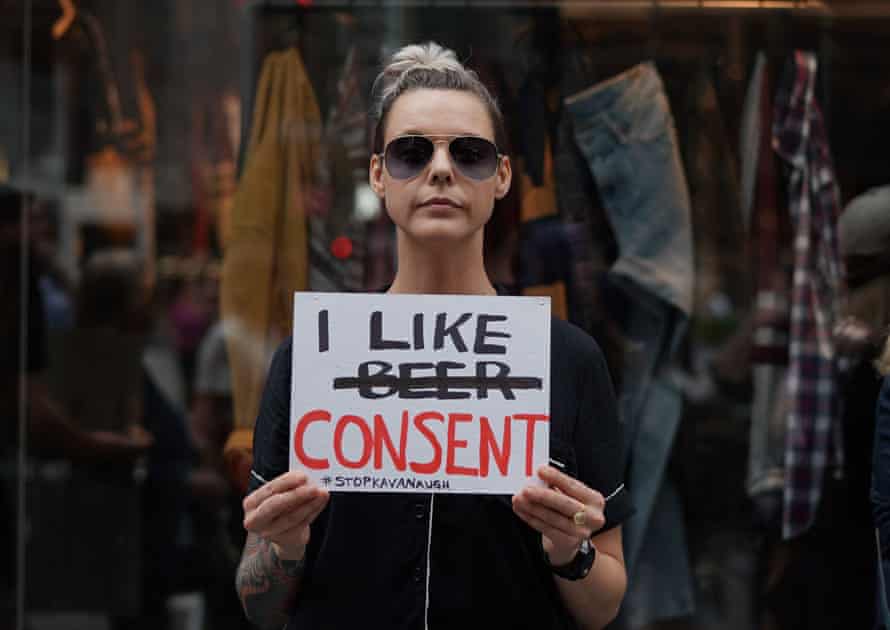 A woman holds a sign during a protest against Brett Kavanaugh outside Trump Tower in New York City on 4 October.